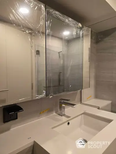 Modern bathroom with sleek fixtures and large mirror