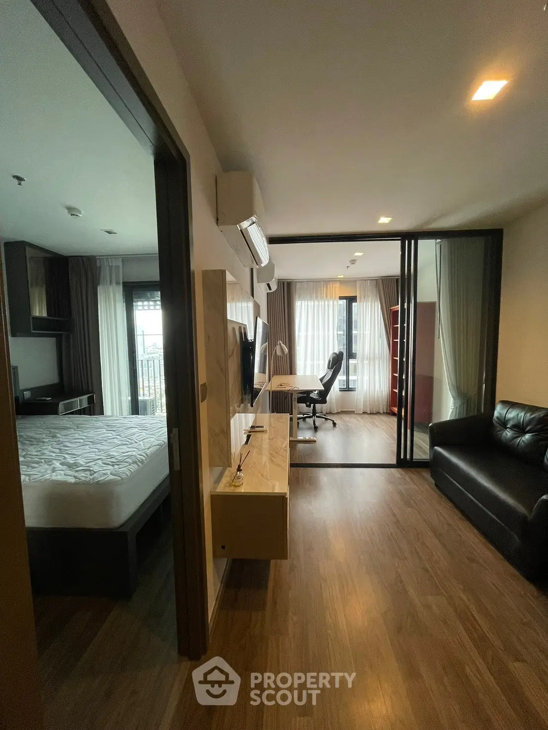 Modern apartment interior with open layout, featuring a cozy living area and stylish bedroom.