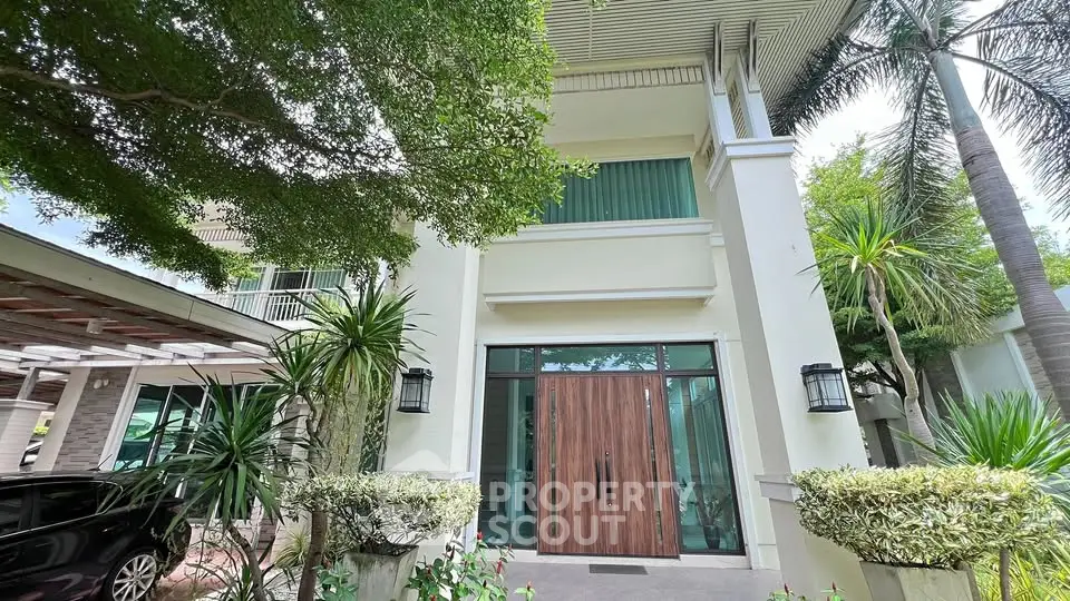 Elegant modern house exterior with lush greenery and large wooden door