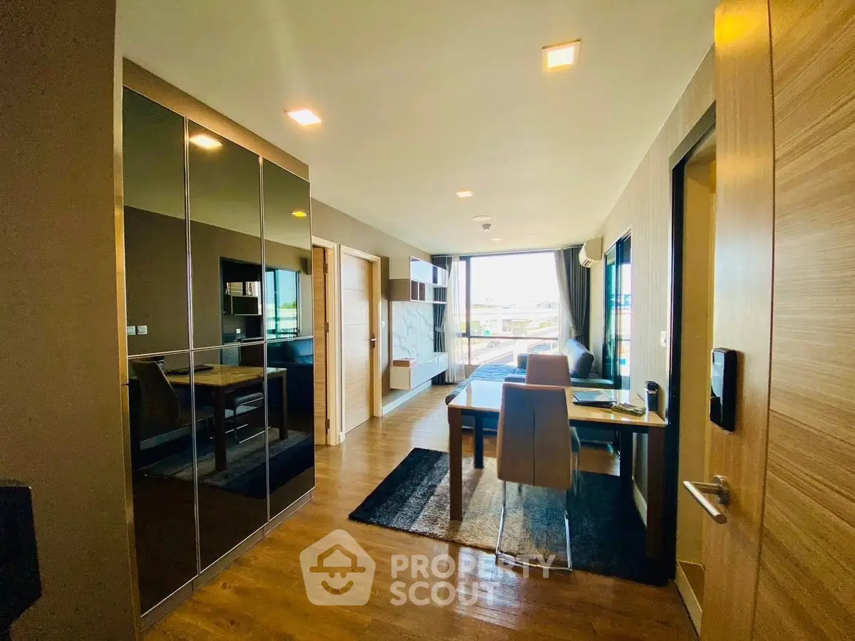 Modern apartment interior with sleek dining area and large windows