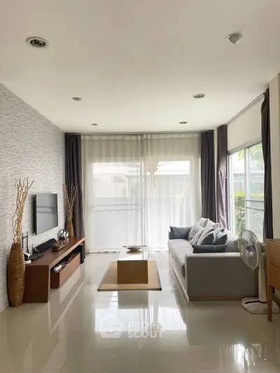 Modern living room with sleek design, large windows, and stylish decor
