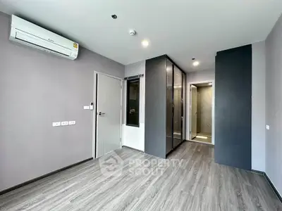 Modern unfurnished bedroom with sleek flooring and built-in wardrobe