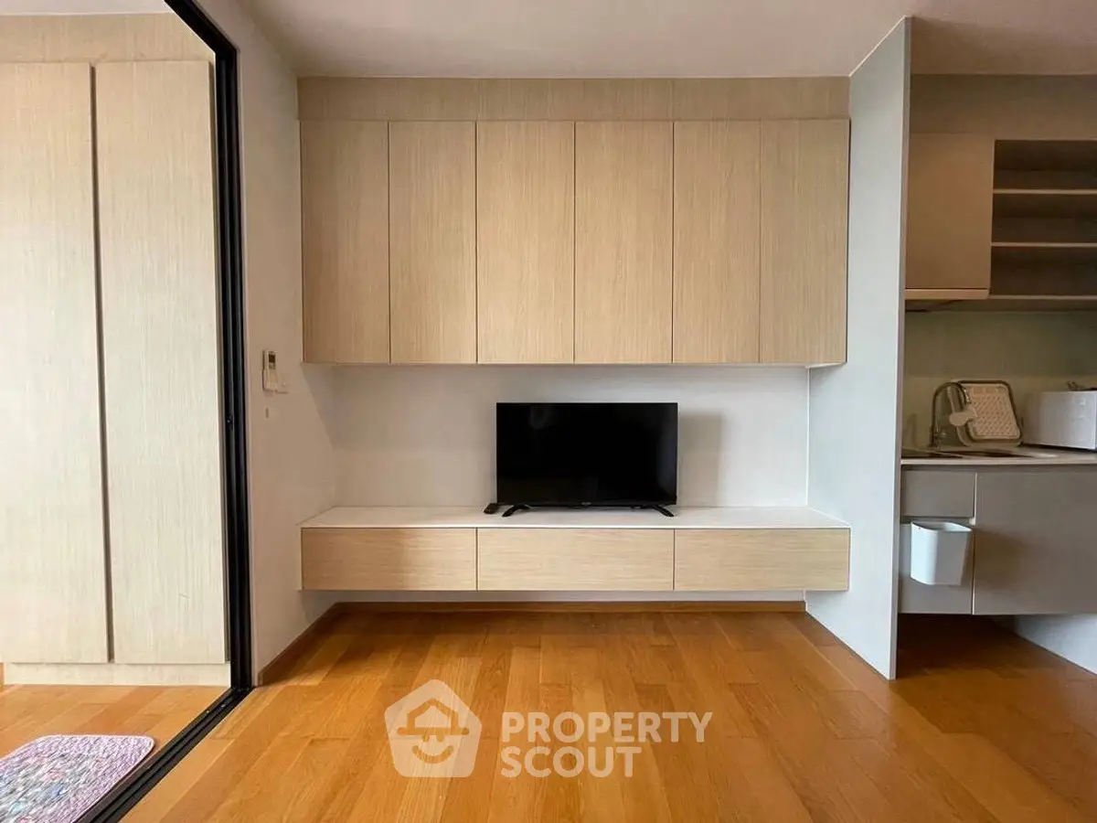 Modern living room with wooden flooring and sleek TV cabinet