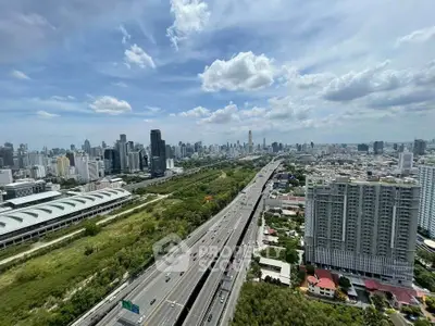 Stunning aerial view of urban skyline with highway and lush greenery, showcasing modern city living.