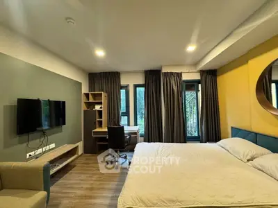 Modern bedroom with study area, large windows, and stylish decor