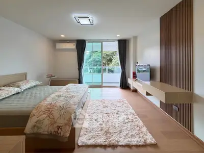 Spacious modern bedroom with balcony access and stylish decor