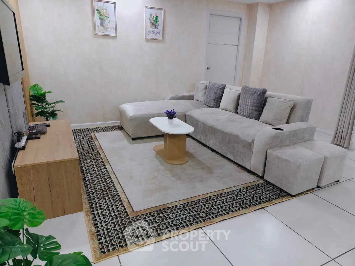 Modern living room with stylish gray sectional sofa and elegant decor