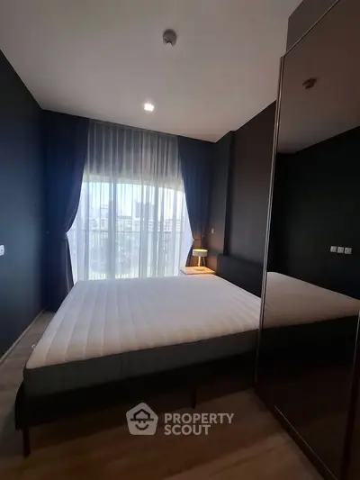 Modern bedroom with large window and stylish dark walls, featuring a comfortable bed and elegant curtains.