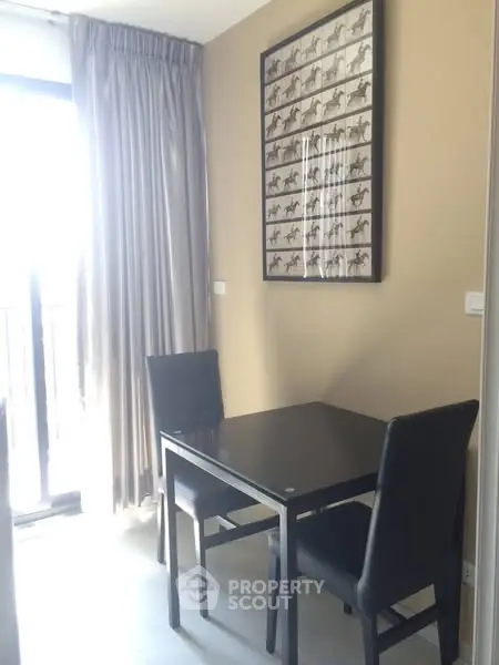 Cozy dining nook with elegant black table and chairs, perfect for intimate meals.