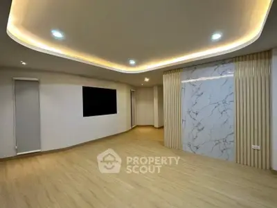 Modern living room with elegant lighting and marble accent wall