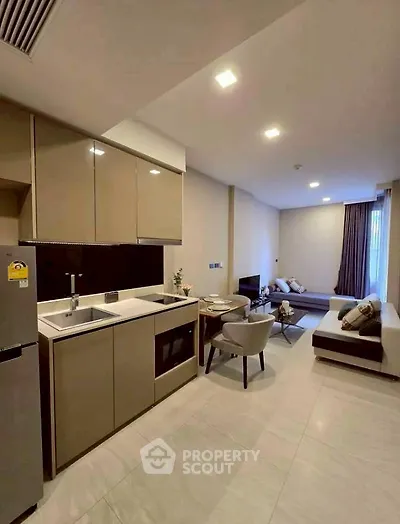 Modern open-plan kitchen and living area with sleek design and cozy ambiance.