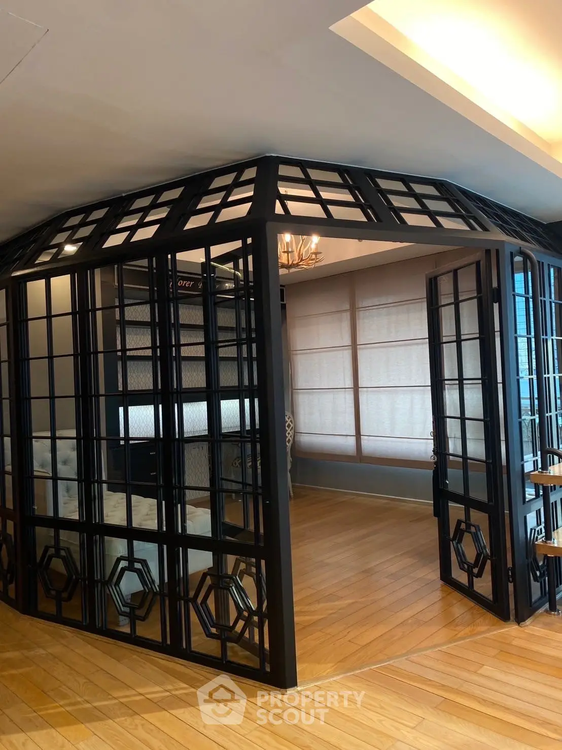 Elegant interior with unique glass partition and wooden flooring