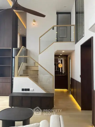 Modern duplex living room with stylish staircase and elegant lighting