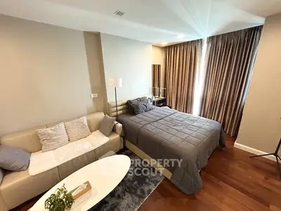 Modern bedroom with cozy sofa and elegant decor