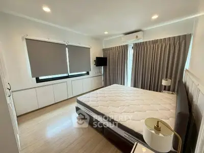 Spacious bedroom with modern decor and natural light