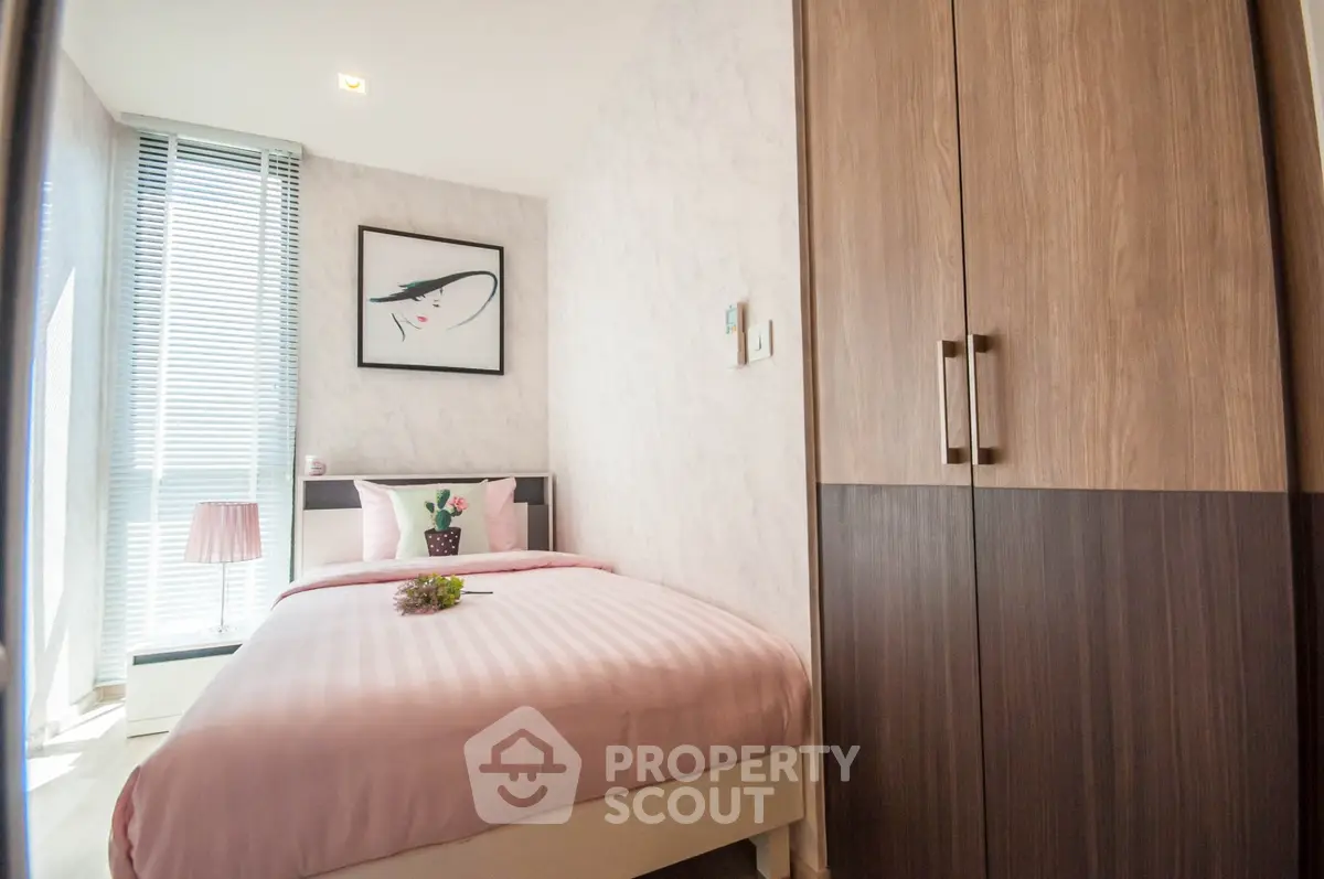 Cozy modern bedroom with stylish decor and ample natural light