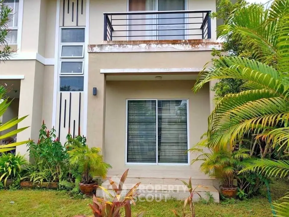 Charming two-story home with lush garden and modern balcony