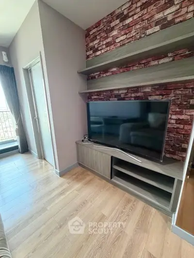 Modern living room with stylish brick accent wall and sleek TV setup