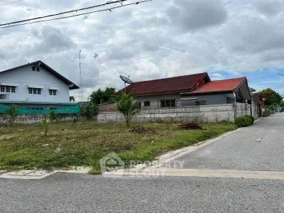 Charming suburban house with red roof and spacious yard, perfect for family living.