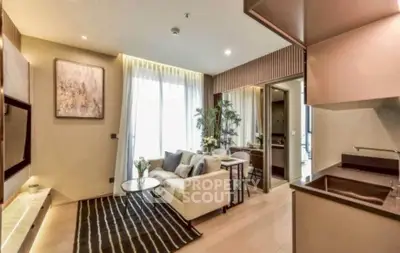 Modern living room with elegant decor and open kitchen layout, featuring cozy seating and stylish lighting.