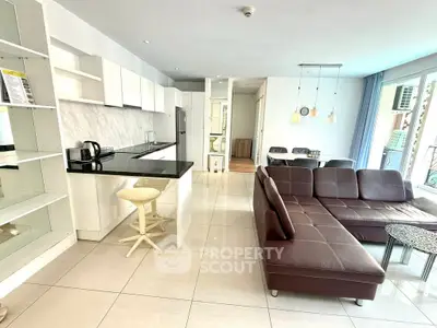 Spacious open-plan living room with modern kitchen and stylish furnishings