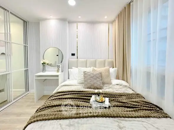 Elegant bedroom with plush bedding and modern decor, featuring a cozy ambiance and stylish design.