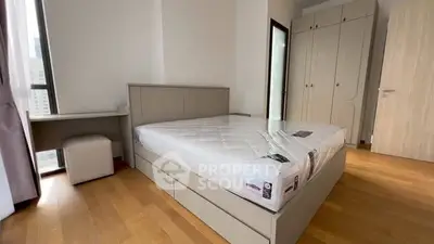 Spacious bedroom with modern furniture and ample natural light