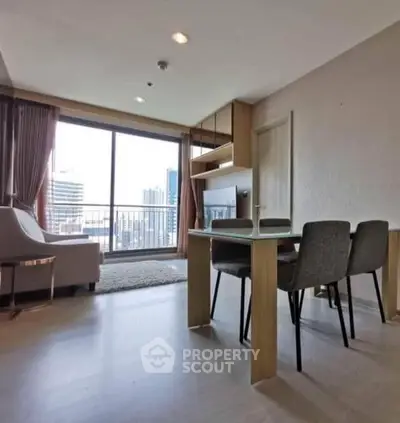 Modern living room with city view and stylish furniture in high-rise apartment.