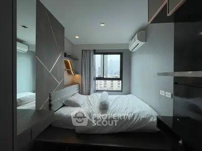 Modern bedroom with city view, featuring sleek design and air conditioning, perfect for urban living.
