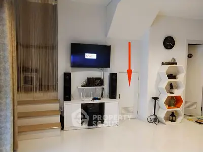 Modern living room with sleek TV setup and unique shelving