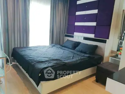 Modern bedroom with stylish decor and large window for natural light