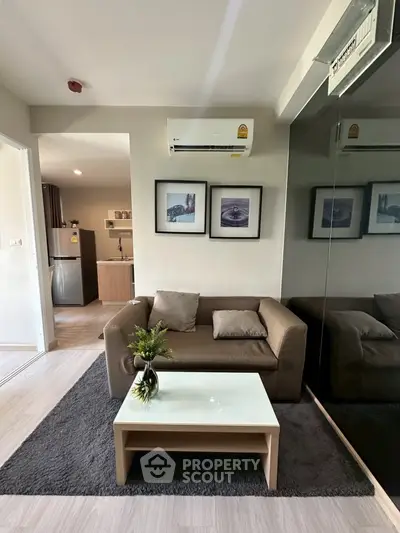 Modern living room with cozy sofa, air conditioning, and stylish decor in a contemporary apartment.