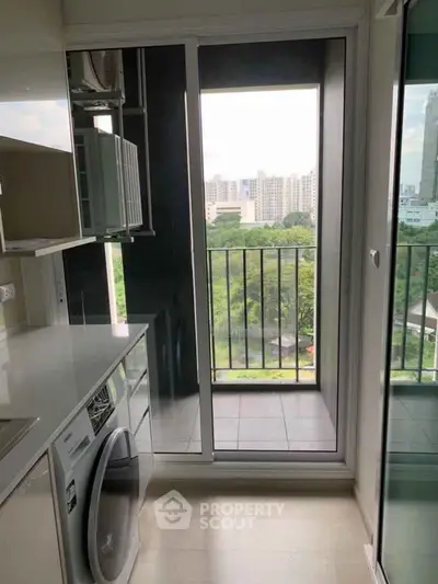 Modern kitchen with balcony view in high-rise apartment