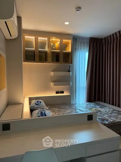 Modern bedroom with built-in storage and natural light, perfect for urban living.
