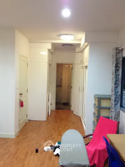 Cozy apartment interior with wooden flooring and ample storage space