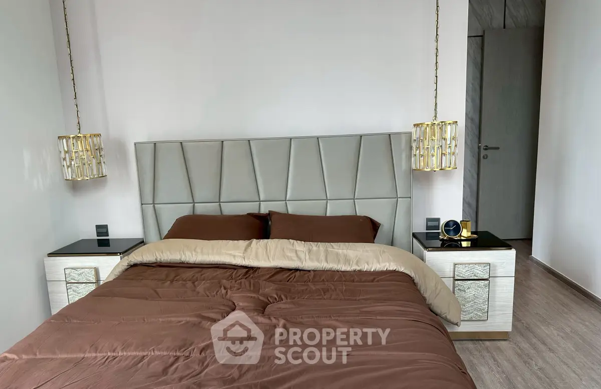 Luxurious bedroom with elegant decor and modern furnishings, featuring a stylish bed and chic lighting.