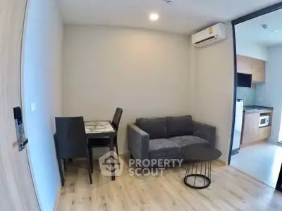 Modern living room with cozy sofa and dining area in open layout apartment