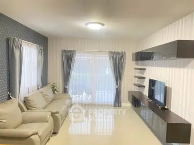 Modern living room with sleek furniture and large windows for natural light.