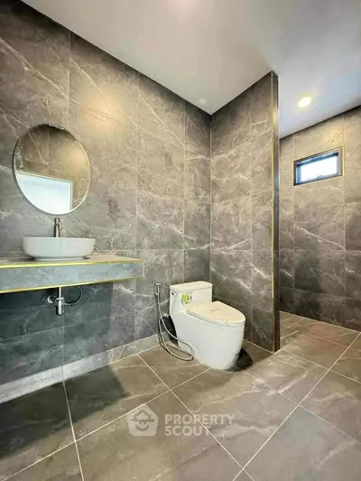 Modern bathroom with sleek gray tiles and minimalist design