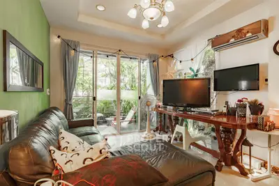 Charming living room with garden view, cozy leather sofa, and stylish decor