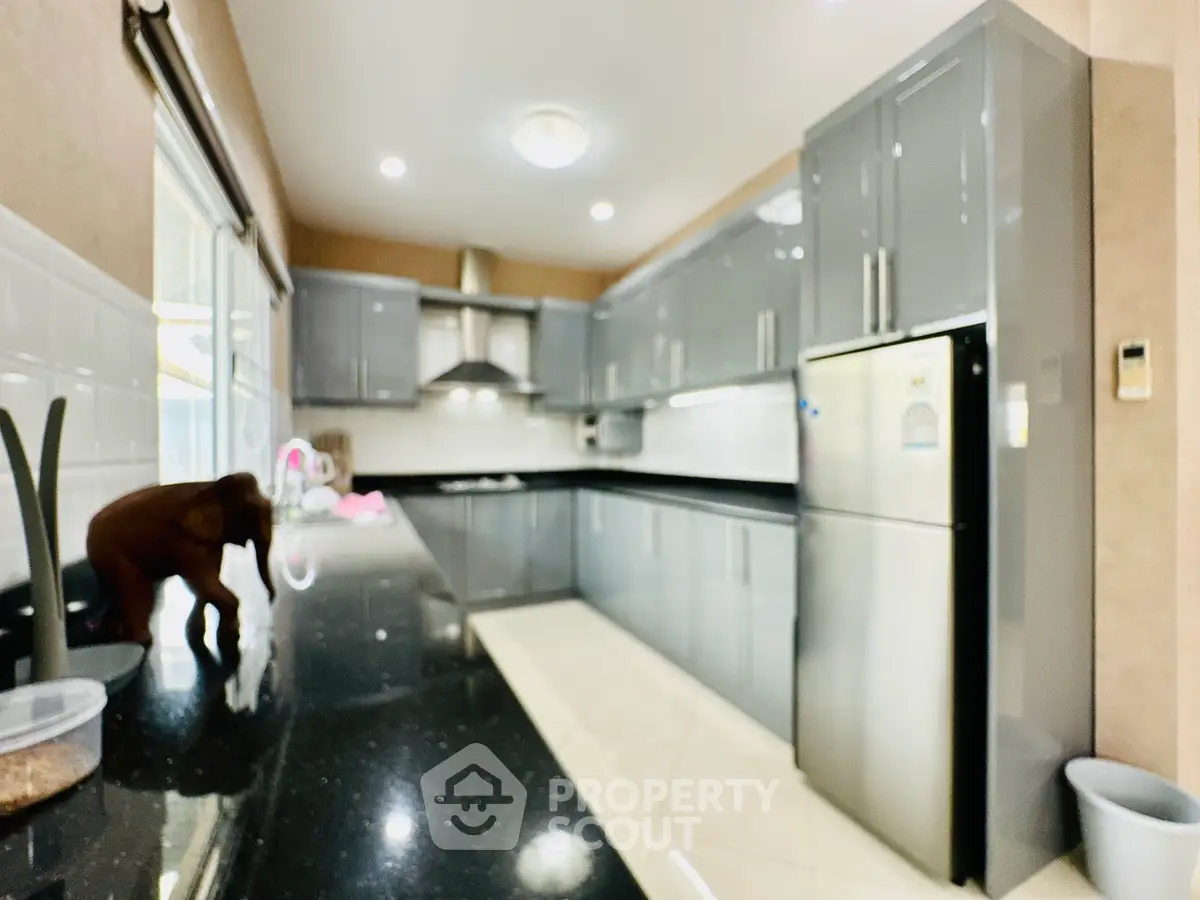Modern kitchen with sleek gray cabinets and stainless steel appliances