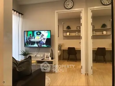 Modern living room with wall-mounted TV and stylish study area