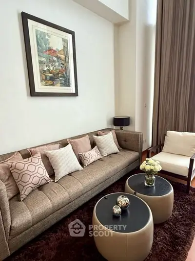 Elegant living room with modern sofa, stylish decor, and cozy ambiance.