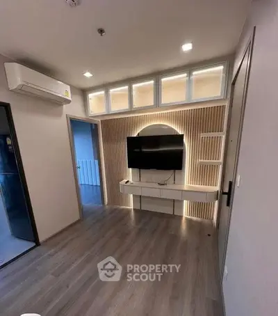 Modern living room with sleek TV setup and stylish lighting
