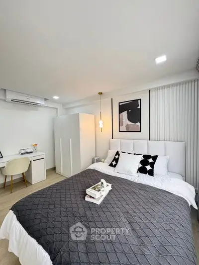 Modern bedroom with stylish decor and cozy ambiance, featuring a comfortable bed and elegant furnishings.