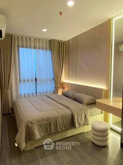 Modern bedroom with elegant lighting and stylish decor in a luxury apartment.
