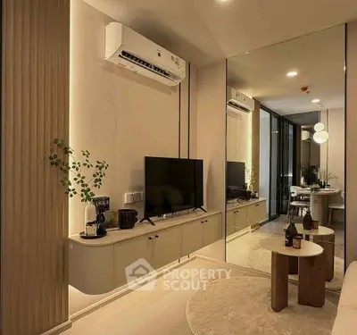 Modern living room with sleek design, featuring wall-mounted TV, air conditioning, and stylish furniture.