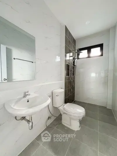 Modern bathroom with sleek fixtures and tiled shower area