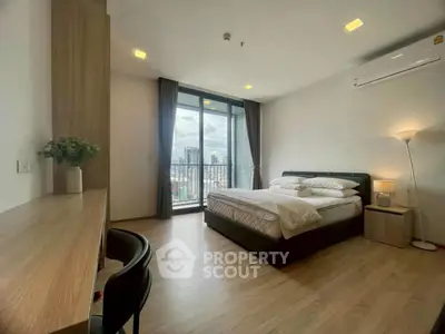 Spacious bedroom with city view and modern furnishings in high-rise apartment