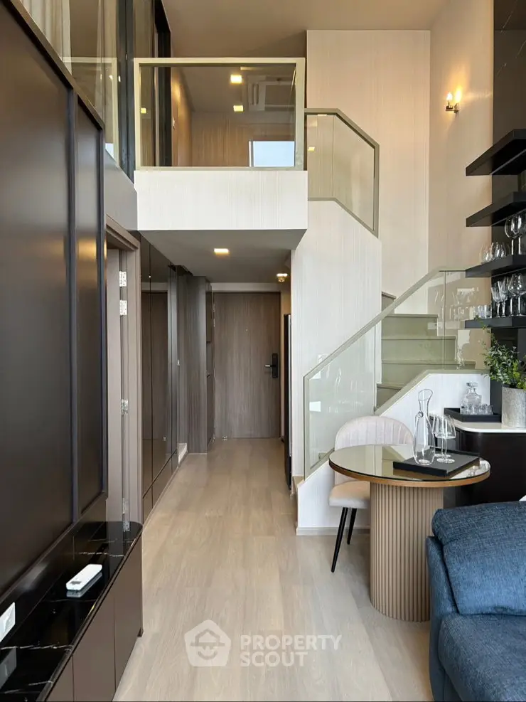 Modern duplex apartment with stylish interior and glass staircase